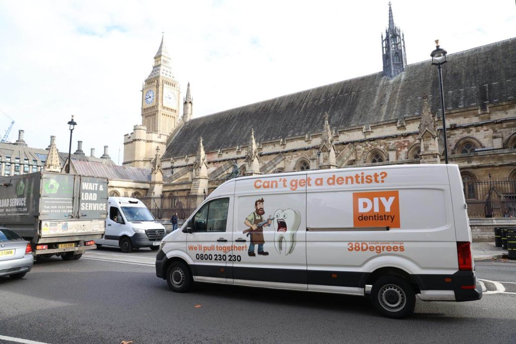 38 Degrees DIY dentistry campaign van driving past Big Ben as part of the NHS dentistry awareness campaign